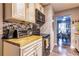 Kitchen featuring white cabinetry, backsplash, stainless steel appliances, and wooden countertops at 3182 Latona Sw Dr, Atlanta, GA 30354