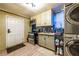 Basement kitchen with appliances, wood countertops, a small sink, mosaic backsplash, tiled floors, and washer/dryer at 3182 Latona Sw Dr, Atlanta, GA 30354