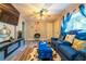 Modern living room featuring hardwood floors, blue sofas, a fireplace and a window at 3182 Latona Sw Dr, Atlanta, GA 30354