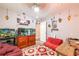 Eclectic living room with two fish tanks, bright decorations, laminate flooring, and a red futon at 3182 Latona Sw Dr, Atlanta, GA 30354