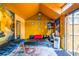 Vibrant orange shed interior featuring a futon, unique decor, and accents, perfect for a studio or office at 3182 Latona Sw Dr, Atlanta, GA 30354