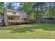 Spacious backyard featuring a lush lawn, deck, pergola and mature trees at 4378 Heritage Glen Ct, Marietta, GA 30068