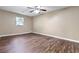 A cozy bedroom features a ceiling fan and attractive wood-look flooring at 4378 Heritage Glen Ct, Marietta, GA 30068
