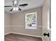 A small bedroom features chair rail trim, a ceiling fan, and wood-look floors at 4378 Heritage Glen Ct, Marietta, GA 30068