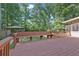 Large deck with railings and a built-in bench overlooking the backyard at 4378 Heritage Glen Ct, Marietta, GA 30068