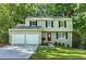 Charming two-story home with a well-manicured lawn, a two-car garage, and a welcoming red front door at 4378 Heritage Glen Ct, Marietta, GA 30068