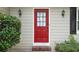 Close-up of the bright red front door framed by sconces and lush greenery at 4378 Heritage Glen Ct, Marietta, GA 30068
