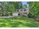 Well-manicured lawn leads up to this two-story home with a welcoming red front door at 4378 Heritage Glen Ct, Marietta, GA 30068