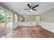 Open concept living room with light walls, ceiling fan and sliding glass doors at 4378 Heritage Glen Ct, Marietta, GA 30068