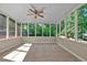 A lovely screened porch offers an attractive ceiling fan and peaceful backyard views at 4378 Heritage Glen Ct, Marietta, GA 30068