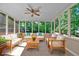Sunroom with ceiling fan and an abundance of seating offering tree views at 4378 Heritage Glen Ct, Marietta, GA 30068