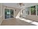 Bright sunroom features tile floor, sliding door, ceiling fan and outdoor access at 4378 Heritage Glen Ct, Marietta, GA 30068