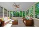 Relaxing sunroom with wicker sofas, armchairs, ceiling fan and window views at 4378 Heritage Glen Ct, Marietta, GA 30068