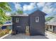 View of backyard with black painted exterior and stone pavers at 445 Westmeath Sw Dr, Atlanta, GA 30310