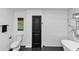 Modern bathroom featuring a soaking tub, black fixtures, and marble and white tiled walls at 445 Westmeath Sw Dr, Atlanta, GA 30310