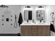 Modern bathroom featuring dual sinks, a glass shower, and black hardware at 445 Westmeath Sw Dr, Atlanta, GA 30310