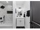 Stylish bathroom features a tub with tiled walls, black fixtures, and modern vanity at 445 Westmeath Sw Dr, Atlanta, GA 30310