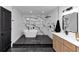 Luxurious bathroom with soaking tub, black hardware, and black and white tile work at 445 Westmeath Sw Dr, Atlanta, GA 30310