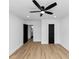 Bright bedroom features a ceiling fan, hardwood floors and black painted doors at 445 Westmeath Sw Dr, Atlanta, GA 30310