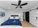 Bright bedroom with hardwood floors, a ceiling fan, and doors leading to a bathroom at 445 Westmeath Sw Dr, Atlanta, GA 30310