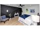 Spacious bedroom featuring a tray ceiling, hardwood floors, and an accent wall at 445 Westmeath Sw Dr, Atlanta, GA 30310