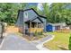 Charming two-story home featuring a covered porch, landscaped yard, and a modern, dark gray exterior at 445 Westmeath Sw Dr, Atlanta, GA 30310