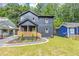 Charming two-story home featuring a covered porch, landscaped yard, and a modern, dark gray exterior at 445 Westmeath Sw Dr, Atlanta, GA 30310