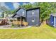 Charming two-story home featuring a covered porch, landscaped yard, and a modern, dark gray exterior at 445 Westmeath Sw Dr, Atlanta, GA 30310