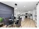 Modern kitchen open to dining area, featuring stainless appliances, pendant lighting, and sleek countertops at 445 Westmeath Sw Dr, Atlanta, GA 30310