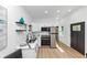 Stylish kitchen with stainless steel appliances, subway tile backsplash, and a black exterior door at 445 Westmeath Sw Dr, Atlanta, GA 30310