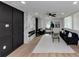 Open living area with hardwood floors, fireplace, black accent wall and lots of natural light at 445 Westmeath Sw Dr, Atlanta, GA 30310