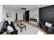 Stylish living room with hardwood floors, black accent wall and a cozy seating area at 445 Westmeath Sw Dr, Atlanta, GA 30310
