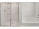 Modern bathroom featuring a glass-enclosed shower and a separate soaking tub at 4932 Jatoba Rd, Acworth, GA 30101