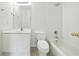 Bright white bathroom featuring a vanity, toilet, and a tub with a shower at 12554 Huntington Trce, Alpharetta, GA 30005