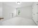 Bright bedroom with plush carpeting, a window, and white walls at 12554 Huntington Trce, Alpharetta, GA 30005