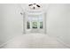 Bright bedroom featuring tray ceiling, ceiling fan, and large windows providing abundant natural light at 12554 Huntington Trce, Alpharetta, GA 30005
