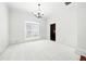 Elegant dining room with carpet, chair rail molding, a chandelier, and large windows offering plenty of light at 12554 Huntington Trce, Alpharetta, GA 30005