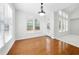 Bright dining room featuring hardwood floors, large windows, and a chandelier, perfect for Gathering gatherings at 12554 Huntington Trce, Alpharetta, GA 30005