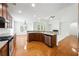 Modern kitchen features granite countertops, stainless appliances, an open concept and hardwood floors at 12554 Huntington Trce, Alpharetta, GA 30005