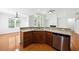 Kitchen with granite countertops, stainless steel appliances, hardwood floors, and open to the living area at 12554 Huntington Trce, Alpharetta, GA 30005