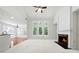 Bright, open living room features a fireplace, large windows, hardwood floors, and a vaulted ceiling at 12554 Huntington Trce, Alpharetta, GA 30005