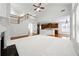 Spacious living room with high ceilings, a fireplace, and an open floor plan with a view of the kitchen at 12554 Huntington Trce, Alpharetta, GA 30005