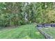 Lush backyard with mature trees offering ample shade and natural beauty at 1610 Windsong Park Dr, Dacula, GA 30019