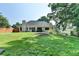 Spacious backyard featuring a well-manicured lawn and landscaping, perfect for outdoor activities at 1610 Windsong Park Dr, Dacula, GA 30019