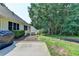This backyard offers a serene view from the patio and includes a grill, a garden bed, and verdant foliage at 1610 Windsong Park Dr, Dacula, GA 30019