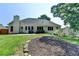 Beautiful backyard with landscaped planting bed and lush green grass, perfect for outdoor enjoyment at 1610 Windsong Park Dr, Dacula, GA 30019