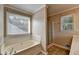 This bathroom is equipped with a soaking tub, a shower, and window for natural light at 1610 Windsong Park Dr, Dacula, GA 30019