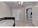 A carpeted bedroom featuring a built-in bed and a doorway leading to a bathroom at 1610 Windsong Park Dr, Dacula, GA 30019