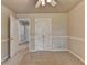 Carpeted bedroom features a ceiling fan and a doorway leading to another room with wood floors at 1610 Windsong Park Dr, Dacula, GA 30019