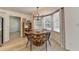 Inviting dining area with stylish lighting, a round table, and natural light streaming through the windows at 1610 Windsong Park Dr, Dacula, GA 30019